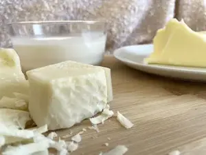 cream, cheese and butter beautifully displayed on a wooden board.