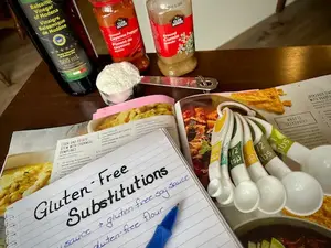 Adapting a recipe using gluten-free substitutions with a cookbook and notes