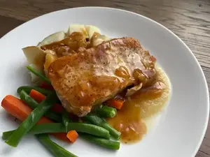 pork chops with gluten-free pan sauce plated with potato and vegetables