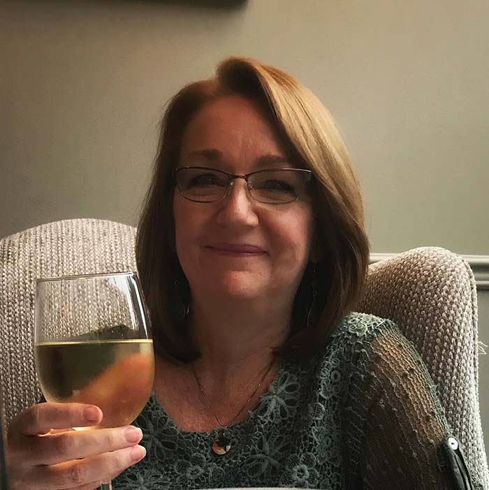 Patty Maguire holding a glass of wine. Patty Maguire holding a glass of wine.