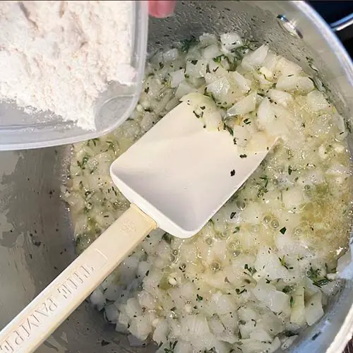 making gluten-free aromatic roux - adding flour to butter and onion