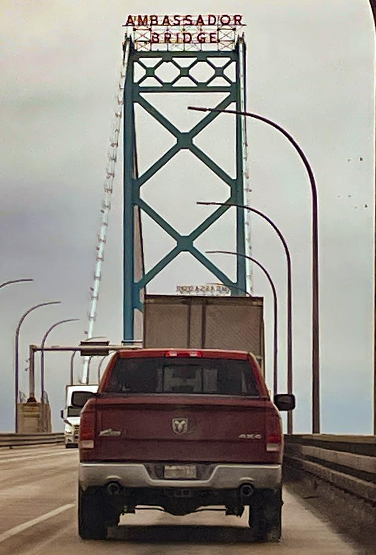 crossing the Ambassador Bridge with red truck  crossing the Ambassador Bridge with red truck