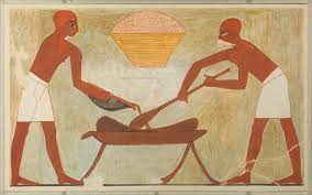 Gluten-free bread. Ancient Egyptian painting of two people making bread with a large loaf of bread in the middle. Gluten-free bread. Ancient Egyptian painting of two people making bread with a large loaf of bread in the middle.