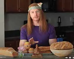 man in hippy costume with bread