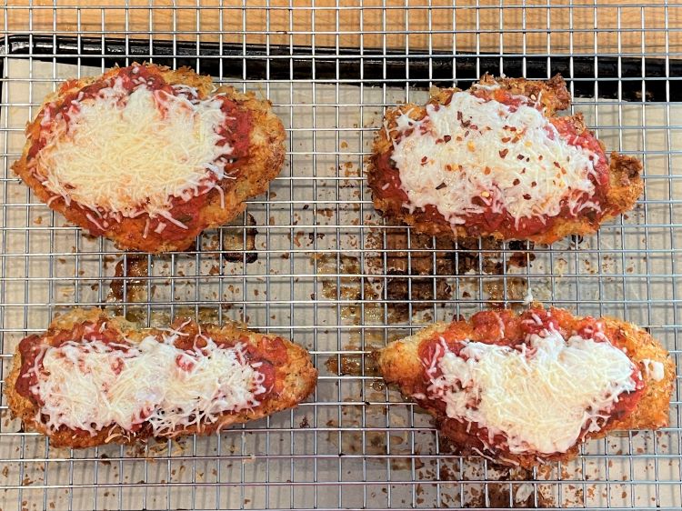 baked chicken parm on a baking rack baked chicken parm on a baking rack