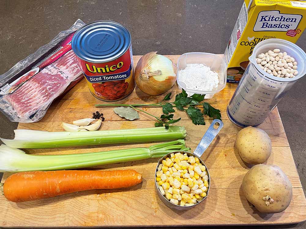 bean and bacon soup ingredients displayed on wooded cutting board bean and bacon soup ingredients displayed on wooded cutting board