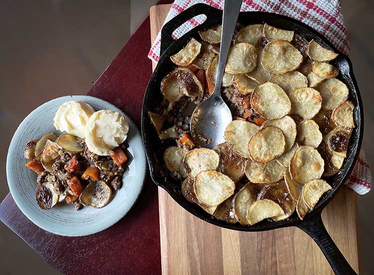 Gluten free beef hotpot plated and in cast iron pan