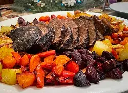 braised beef potroast on a platter with potatoes and veggies