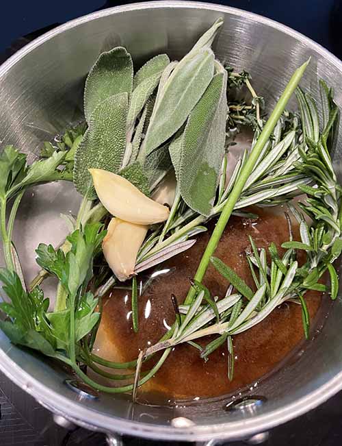 brown sugar, garlic and green herbs in a sauce pan.