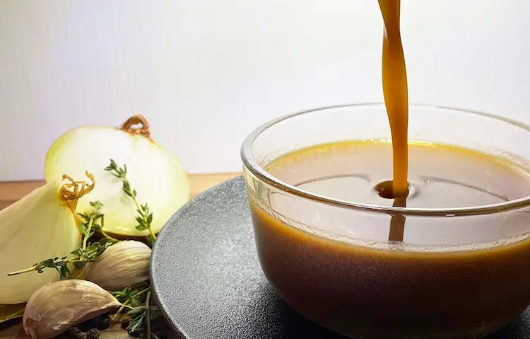Pouring brown sauce into glass bowl