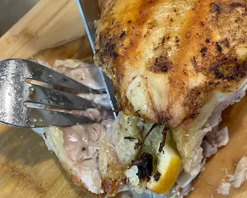removing thigh from roasted chicken