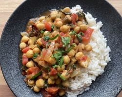 chana masala with white rice on black plate
