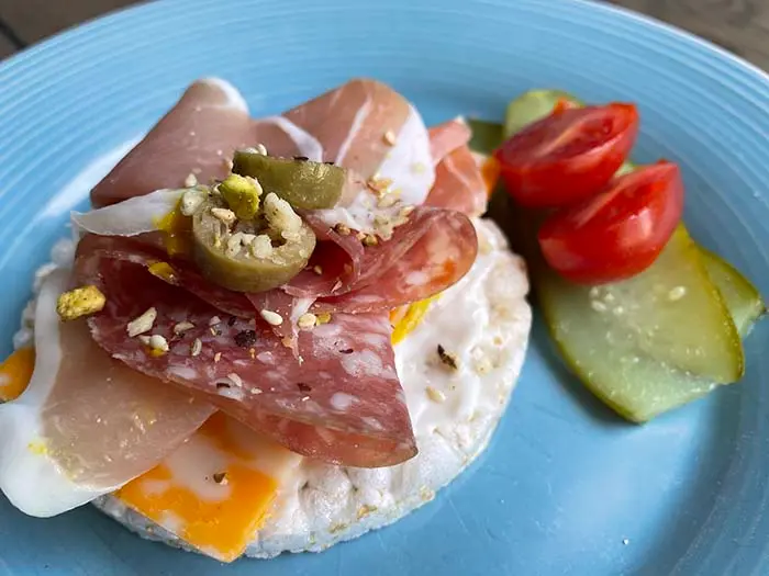charcuterie rice cake with cold cuts and pickle