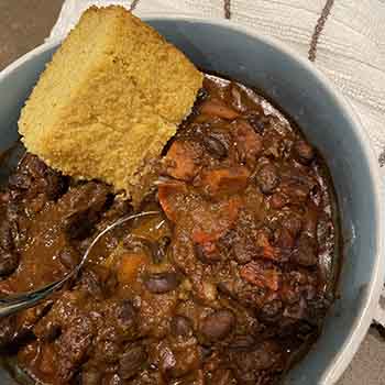 cheater black bean chili in bowl with corn bread