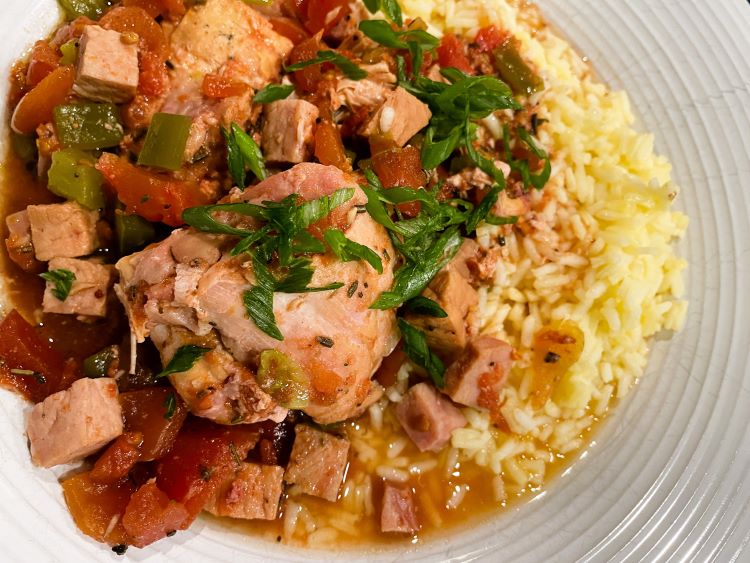 slow cooker chicken basque with rice on white plate