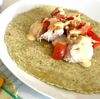 Leftover chicken and sauce on a gluten-free wrap.