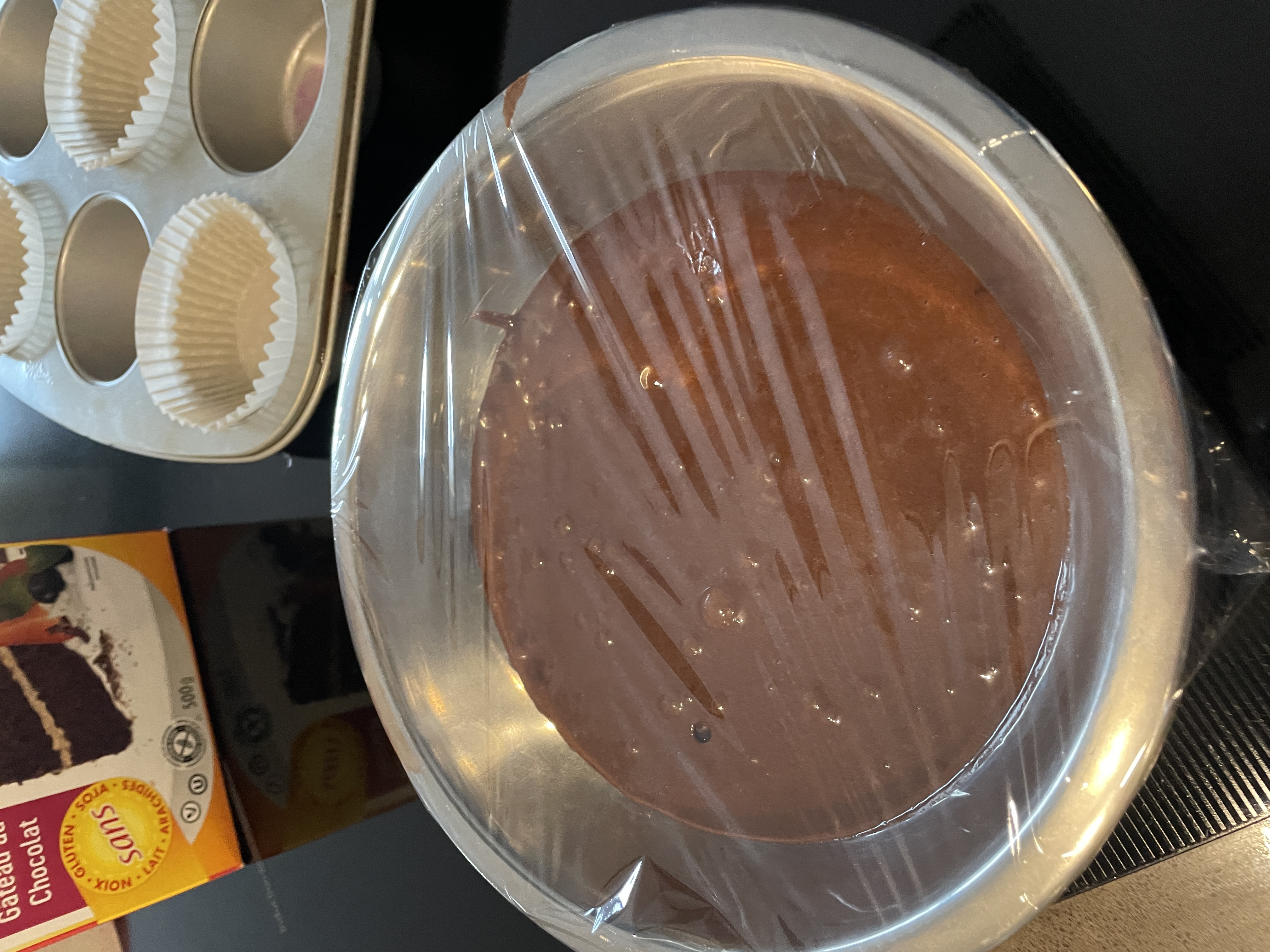 chocolate cake batter in a bowl covered with plastic wrap chocolate cake batter in a bowl covered with plastic wrap