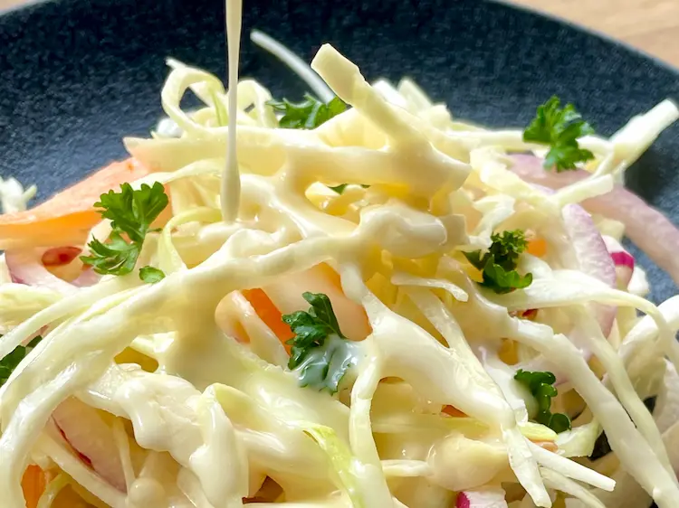gluten-free salad dressing poured over coleslaw