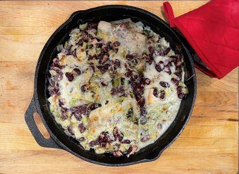 creamy fish and beans in a cast iron pan creamy fish and beans in a cast iron pan