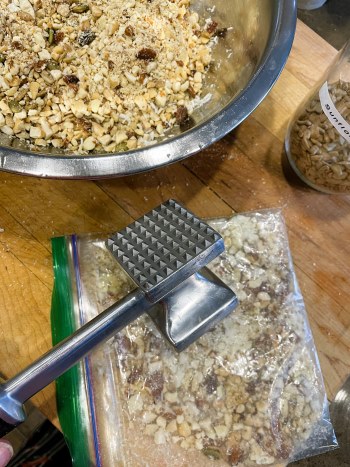 mixed nuts in Ziploc bag with mallet