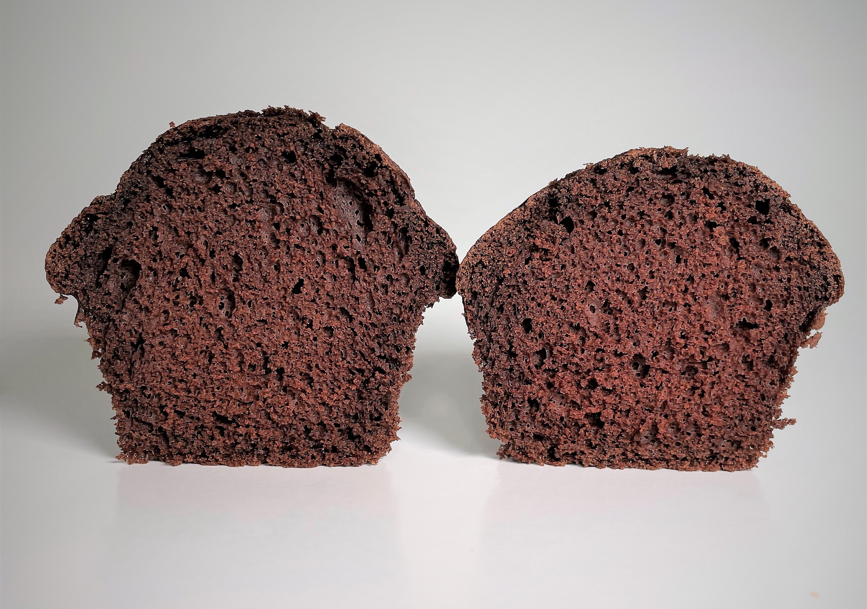 Two cupcakes.  One is taller than the other.