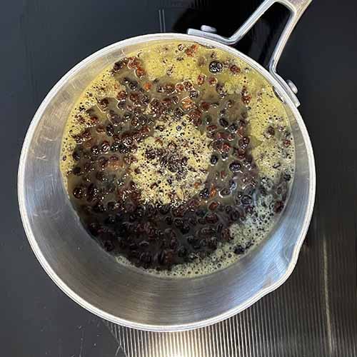 pot of currants soaking in orange juice