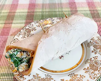 deli-chicken wrap on a decorative gold plate