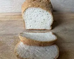 Gluten-Free Bread: sliced loaf of white bread on a wooden cutting board. Gluten-Free Bread: sliced loaf of white bread on a wooden cutting board.