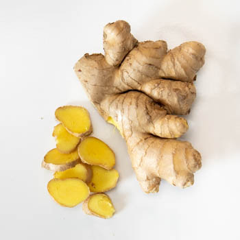 whole fresh ginger root with sliced ginger whole fresh ginger root with sliced ginger