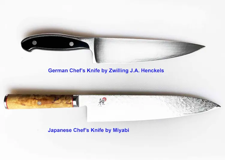 A German chef's knife and a Japanese chef's knife on a white cutting board. A German chef's knife and a Japanese chef's knife on a white cutting board.