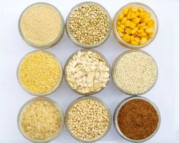 Nine jars of gluten free grain on a rustic white background. Nine jars of gluten free grain on a rustic white background.