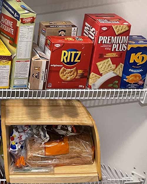 Pantry shelves showing gluten containing food. Bread in a breadbox, cereal and crackers. Pantry shelves showing gluten containing food. Bread in a breadbox, cereal and crackers.
