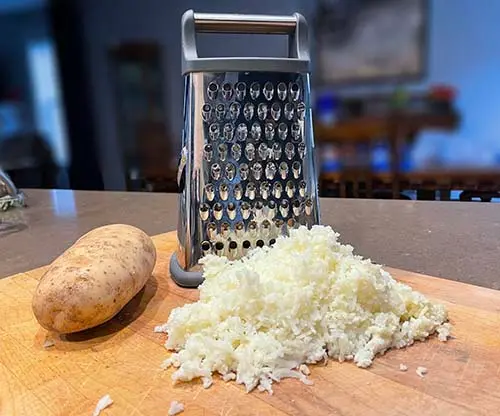 box grater with grated potato box grater with grated potato