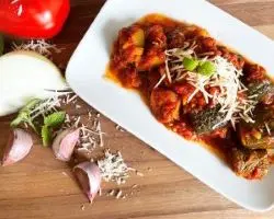 greek zucchini stew on white plate with garlic and onion greek zucchini stew on white plate with garlic and onion