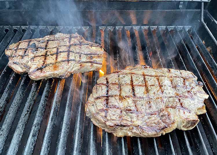cooking steak on outdoor grill cooking steak on outdoor grill