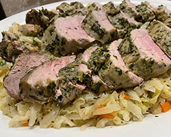 herbed pork tenderloin plated with warm cabbage salad