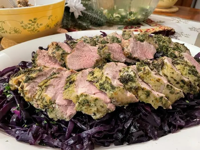 herbed pork tenderloin on a bed of purple cabbage salad