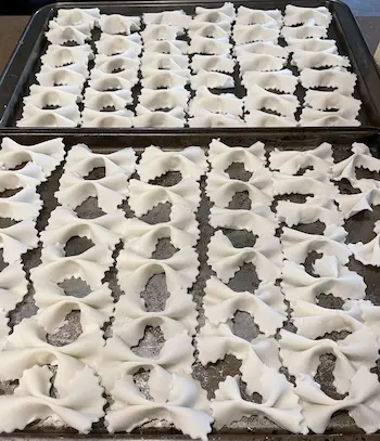 homemade gluten free farfalle on baking trays homemade gluten free farfalle on baking trays