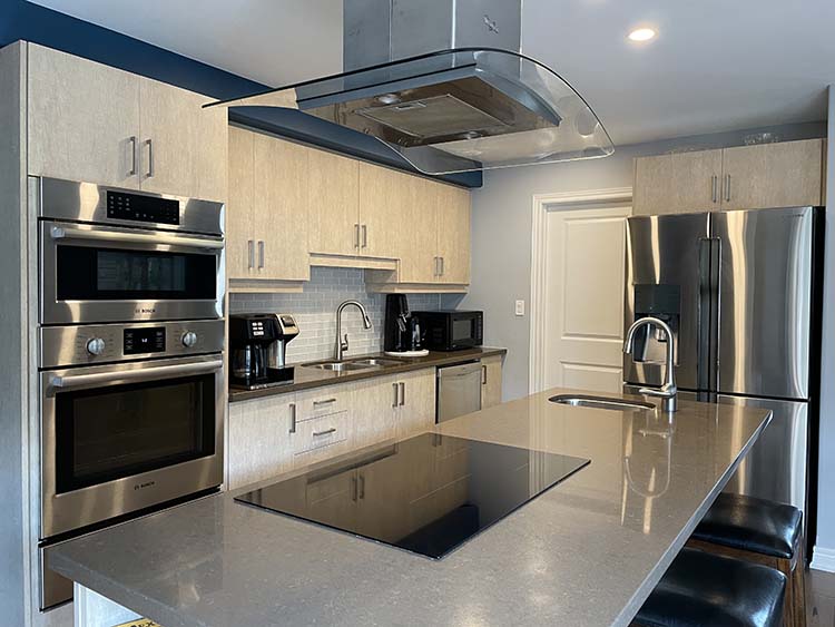 gluten-free kitchen with stainless steel appliances and glass range hood over island. gluten-free kitchen with stainless steel appliances and glass range hood over island.