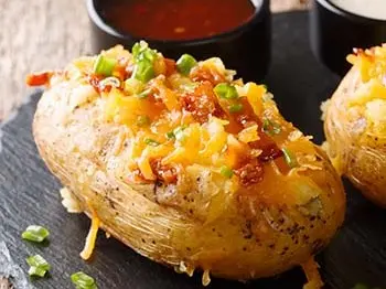 baked potato topped with bacon and cheddar.