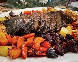 braised pot roast on platter with roasted vegetables braised pot roast on platter with roasted vegetables