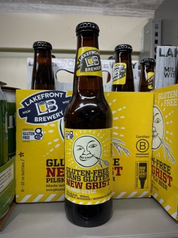 New Grist gluten free beer on shelf beside case. New Grist gluten free beer on shelf beside case.