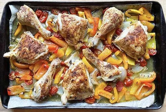 sheet pan meal with chicken legs, peppers and tomatoes. sheet pan meal with chicken legs, peppers and tomatoes.