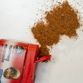 ground nutmeg spilling from container ground nutmeg spilling from container