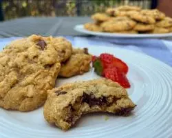 gluten free oatmeal cookies close-up with strawberries and plate of cookies in background