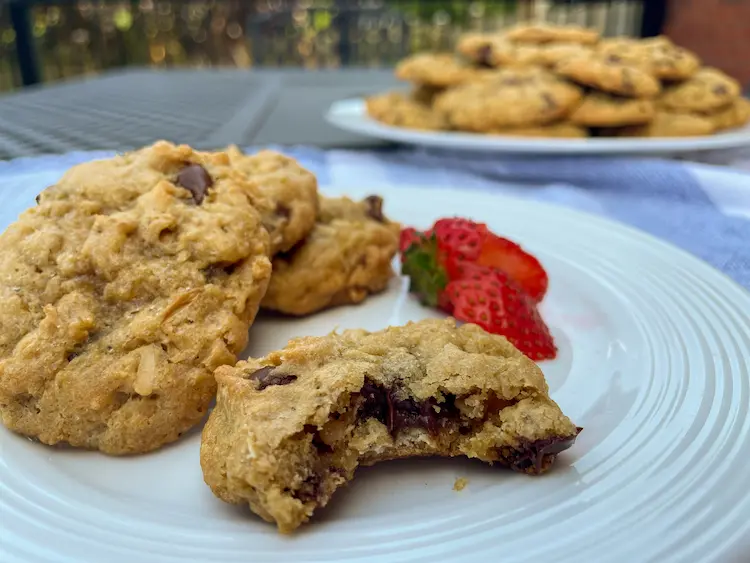 oatmeal cookies closeup with strawberry and plate of cookies in background