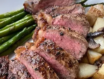 Sliced Steak dinner of sirloin steak with potatoes and asparagus