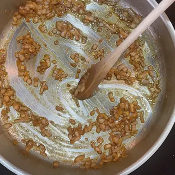 stirring wine into pan sauce