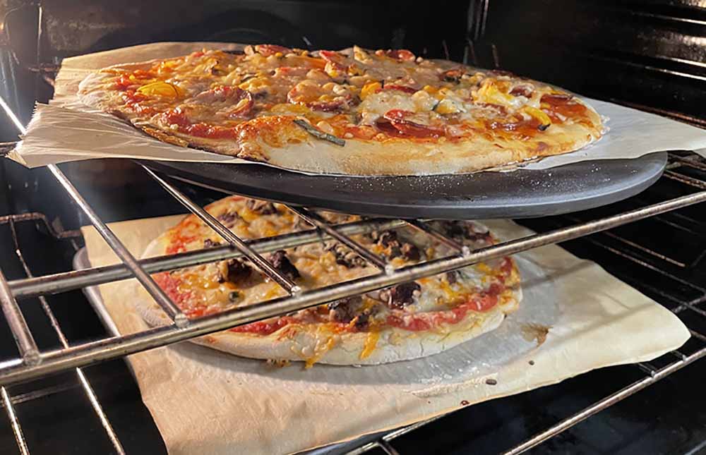 two pizzas in the oven two pizzas in the oven