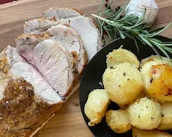 pork loin roast with roasted potatoes and rosemary